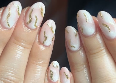 Stylish golden-accented nails at Pops Beauty Studio, Gwent, Wales, GB, showcasing elegance and creativity.