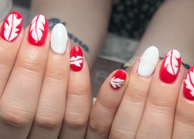 Red and white leaf nail art at Pops Beauty Studio, Gwent, Wales, GB.