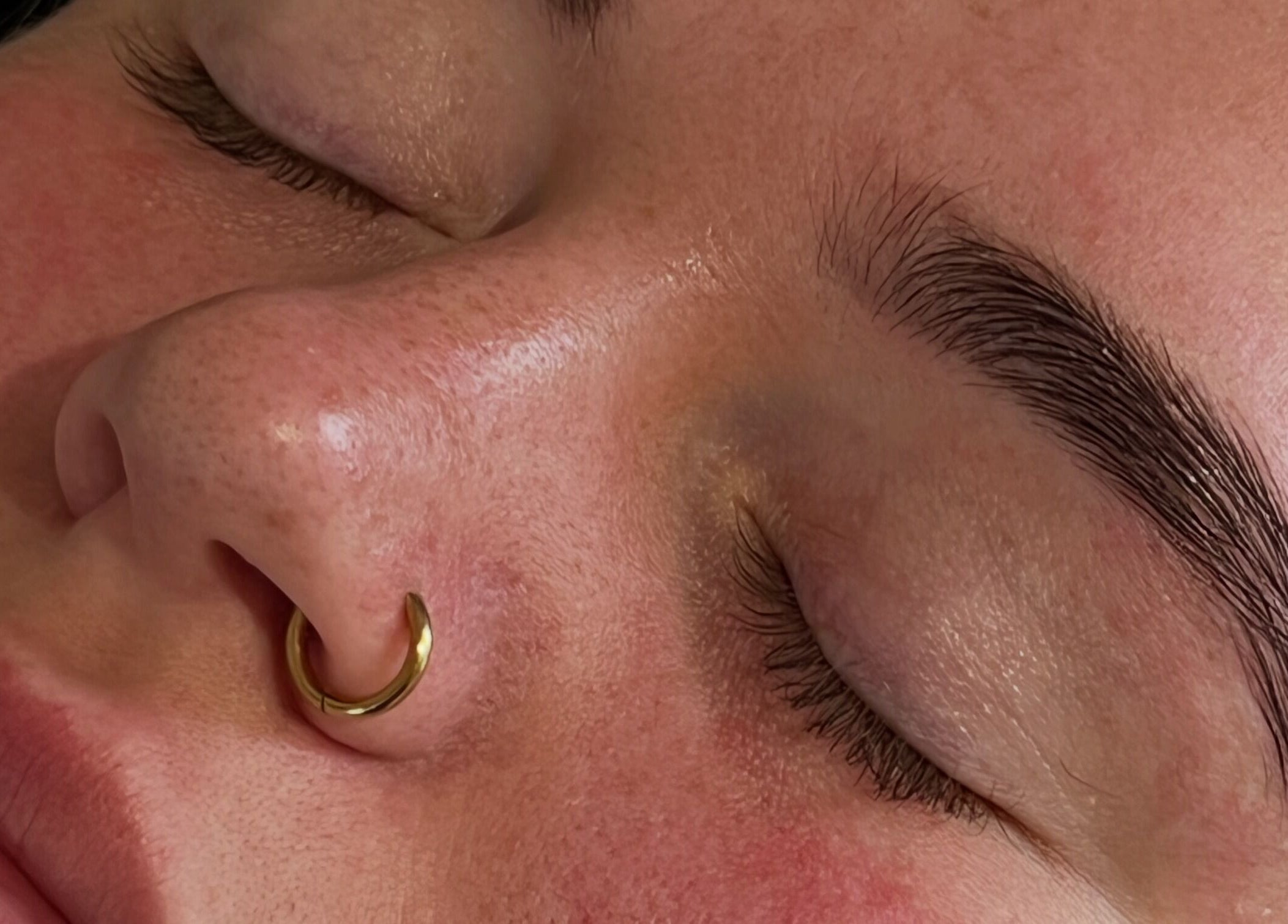 Close-up of serene face and brows at PopsBeautyStudio, Bettws, Newport, Wales, GB.