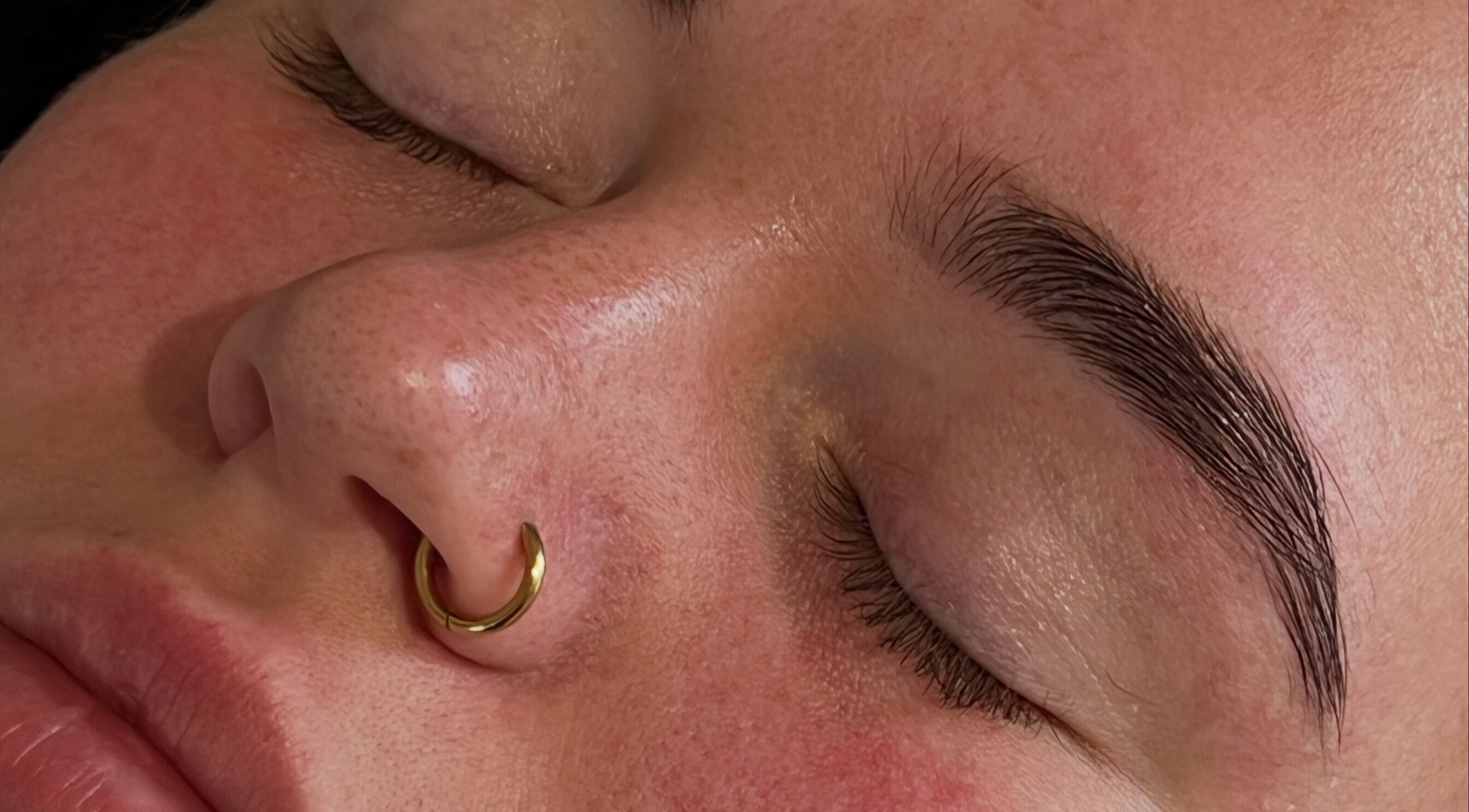 Close-up of serene face and brows at PopsBeautyStudio, Bettws, Newport, Wales, GB.