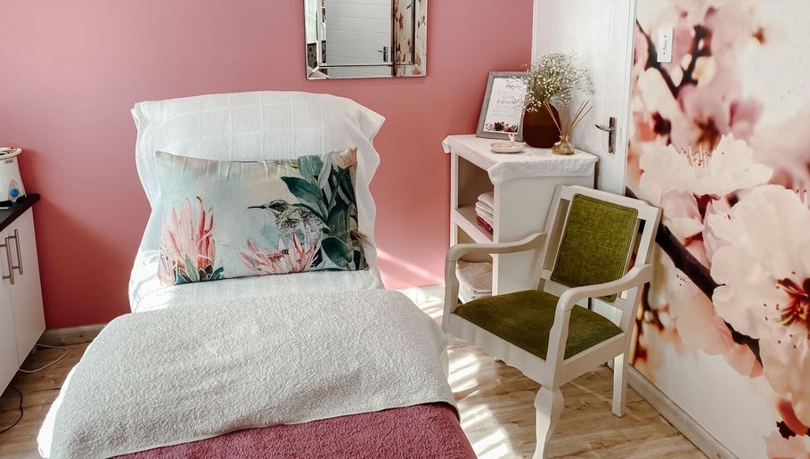 Cozy treatment room at Spatique, Cape Town, featuring soft decor and floral accents in Western Cape, ZA.