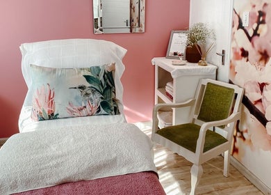 Cozy treatment room at Spatique, Cape Town, featuring soft decor and floral accents in Western Cape, ZA.