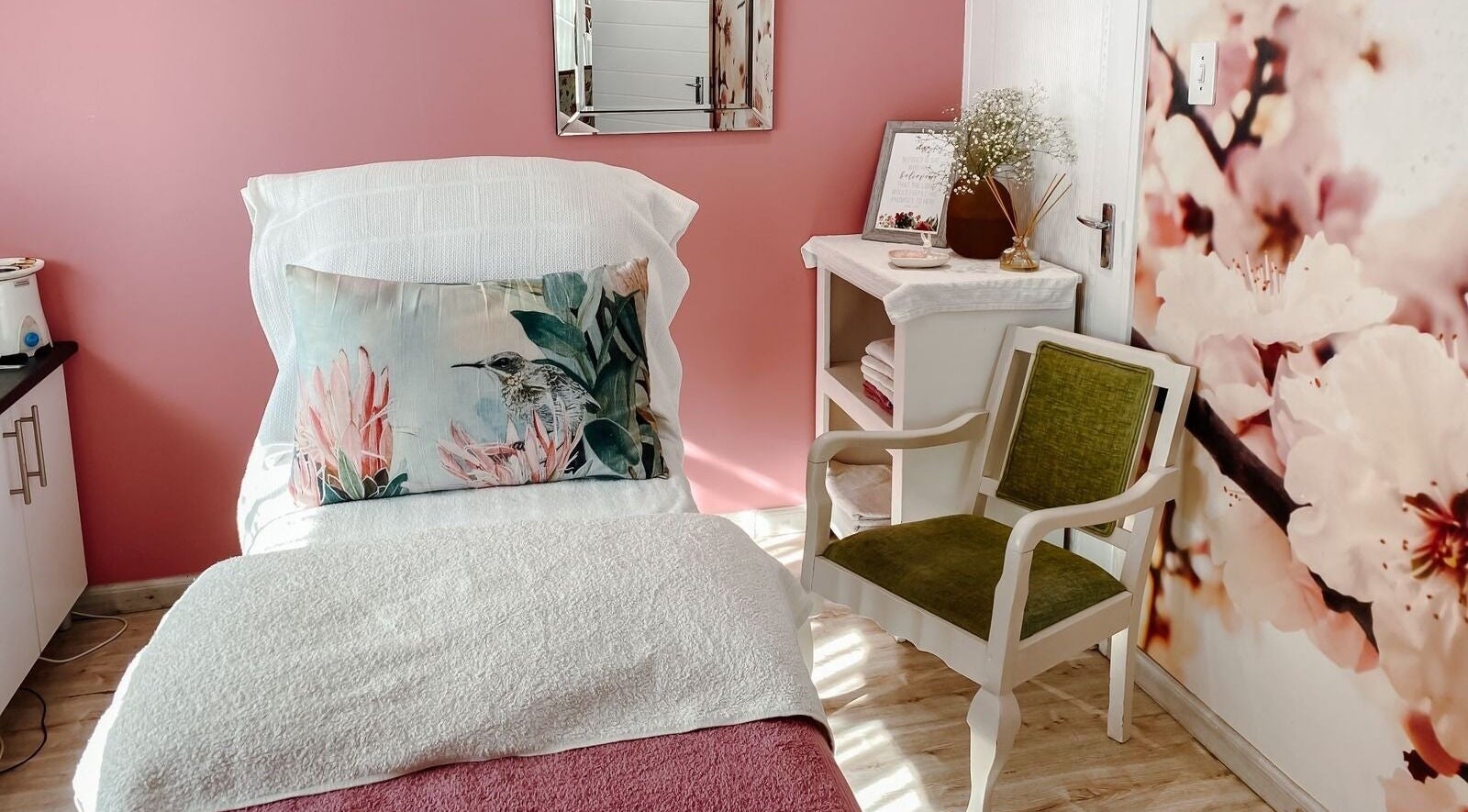 Cozy treatment room at Spatique, Cape Town, featuring soft decor and floral accents in Western Cape, ZA.