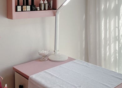 Chic nail station at Spatique, Cape Town, Western Cape, ZA with a pink chair and soft lighting.