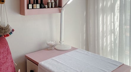 Chic nail station at Spatique, Cape Town, Western Cape, ZA with a pink chair and soft lighting.
