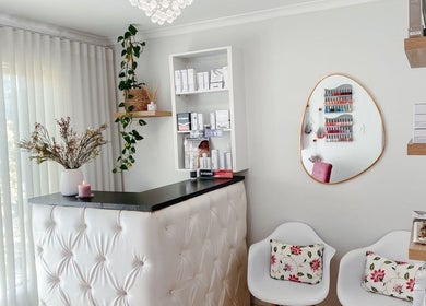 Spatique reception in Cape Town, Western Cape, ZA features chic decor with plush seating and beauty products.