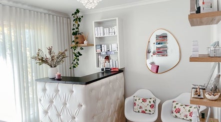 Spatique reception in Cape Town, Western Cape, ZA features chic decor with plush seating and beauty products.