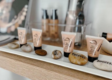 Skincare products and engraved stones at Spatique, Cape Town, Western Cape, ZA, creating a serene ambiance.