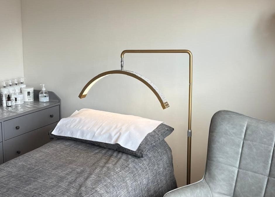 Modern treatment room at One to One Beauty, Huntingdon, England, GB with a bed and elegant lighting.