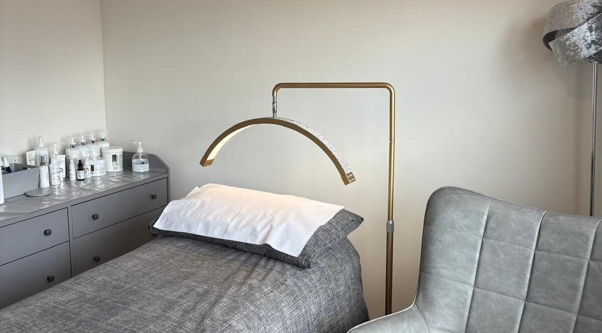 Modern treatment room at One to One Beauty, Huntingdon, England, GB with a bed and elegant lighting.