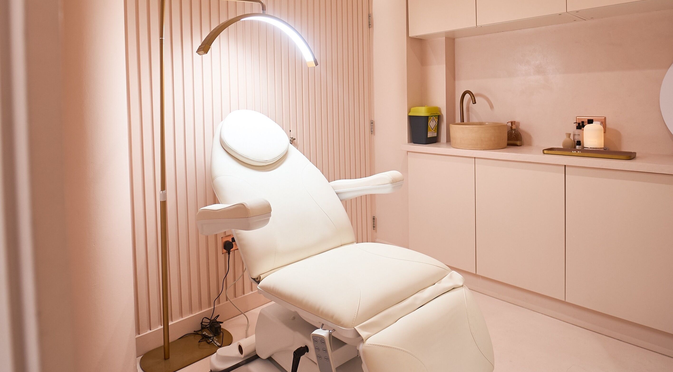 A calming treatment room at Skins Clinic, Manchester, England, GB featuring a sleek white reclining chair.