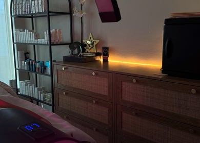 Tranquil treatment room at Shades of Skin Beauty Bar in Vaughan, Ontario, CA with skincare products and awards.