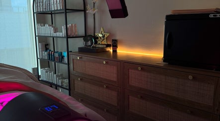 Tranquil treatment room at Shades of Skin Beauty Bar in Vaughan, Ontario, CA with skincare products and awards.