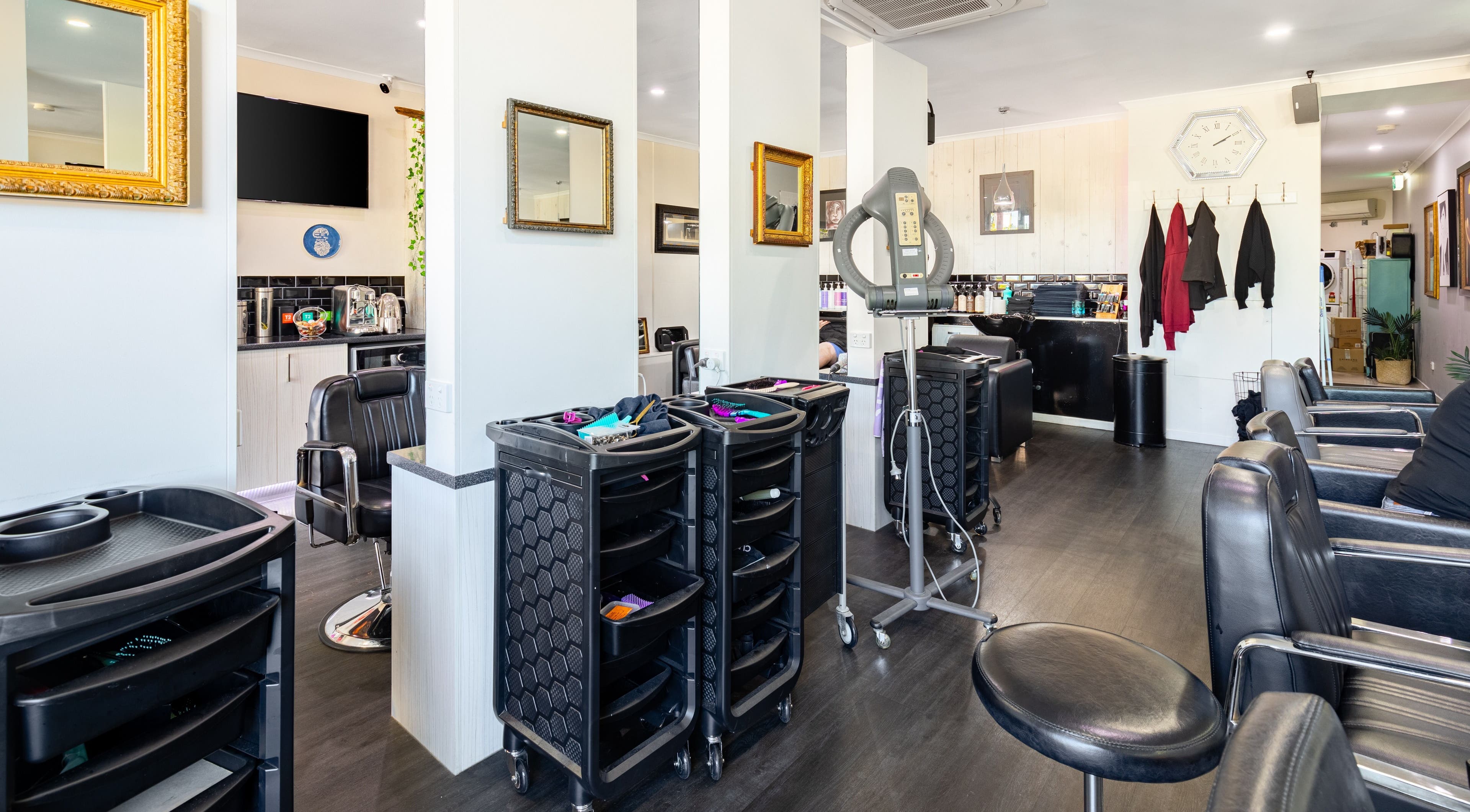 Interior view of Marcia Gibsons Hair Fashions, Everton Hills, QLD, AU showcasing chic salon setup.