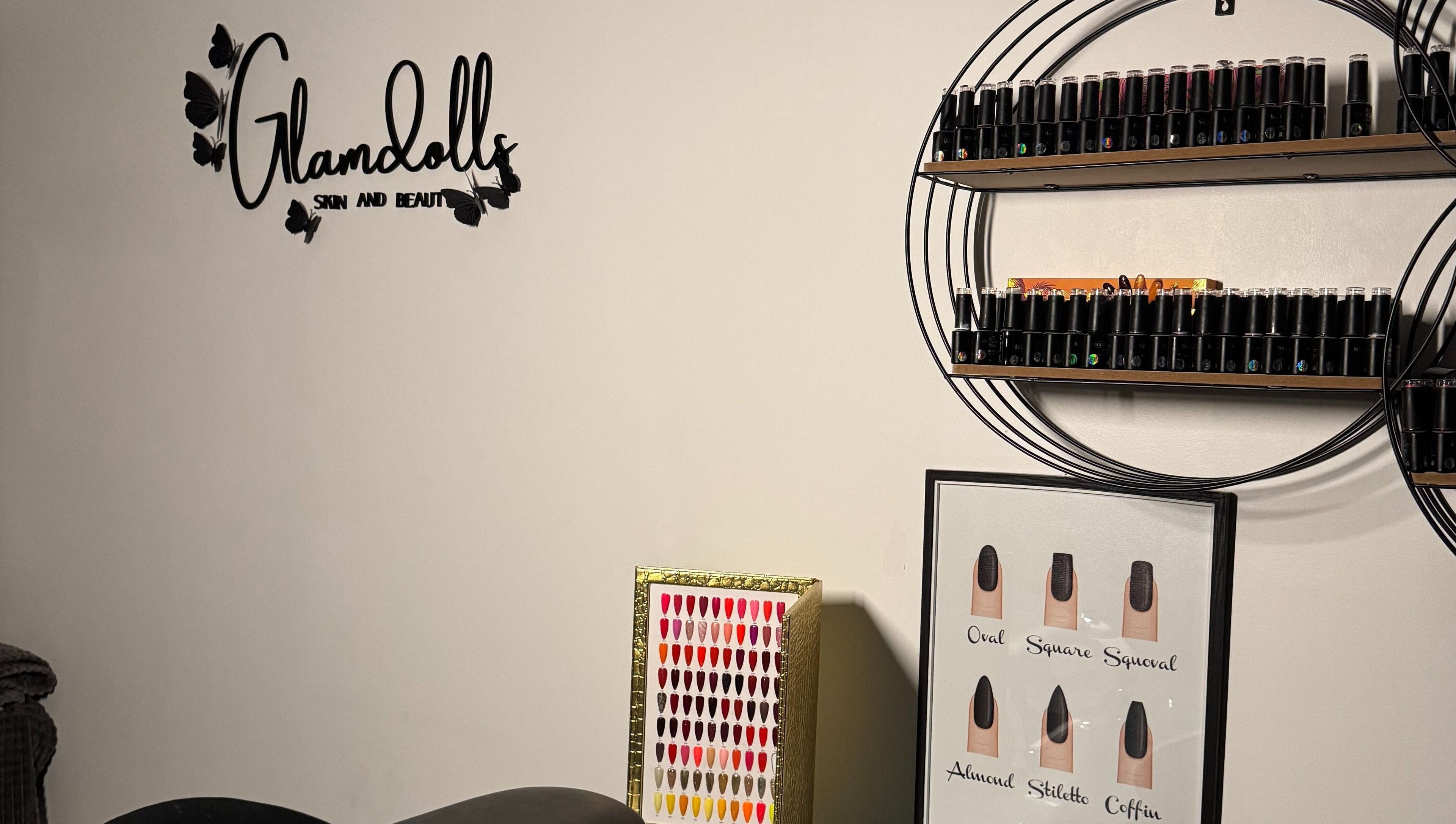Glamdolls salon in Dublin, County Dublin, IE with nail polish display and logo on wall.