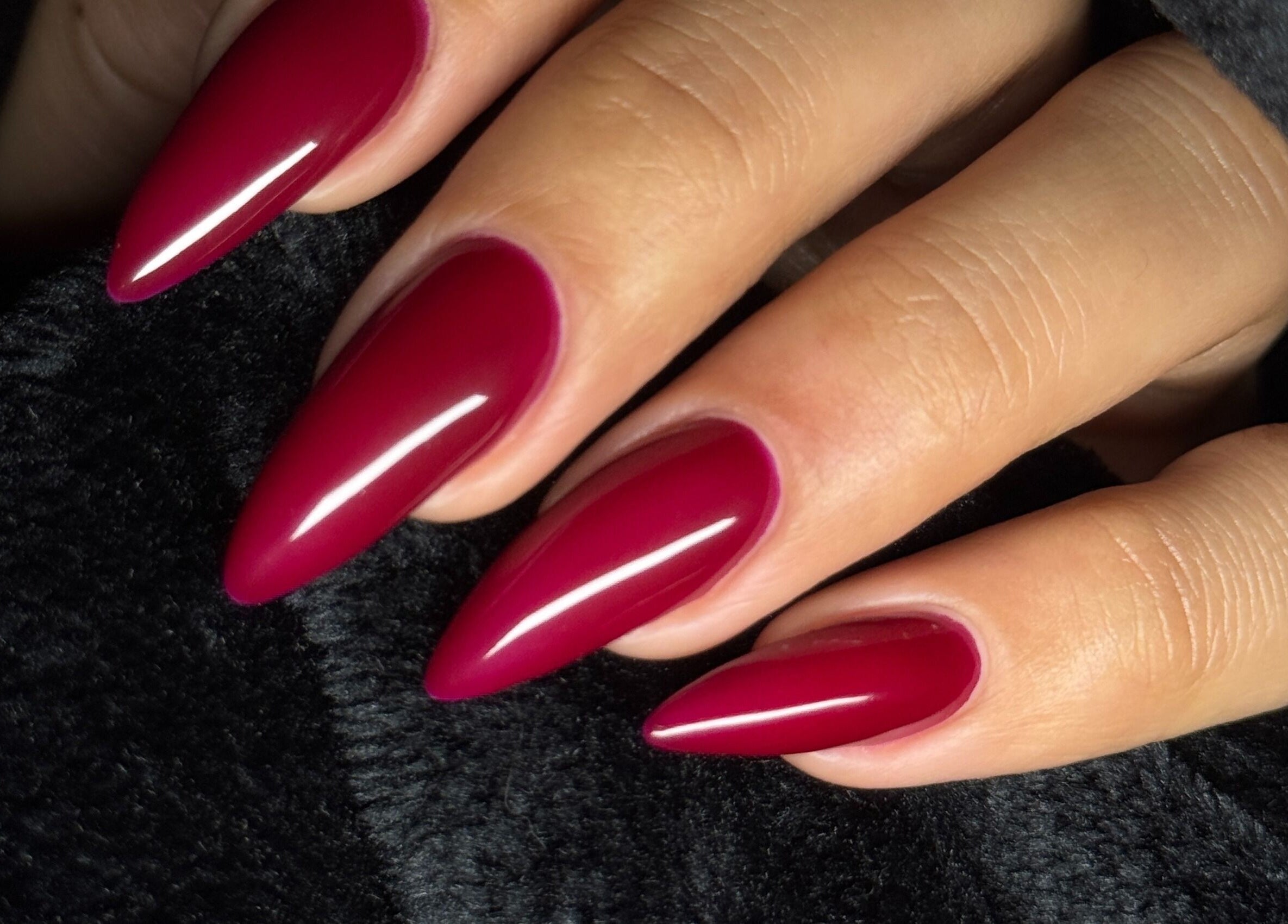 Stunning manicured nails in deep red from Glamdolls, Dublin, County Dublin, IE; elegant and glossy finish.