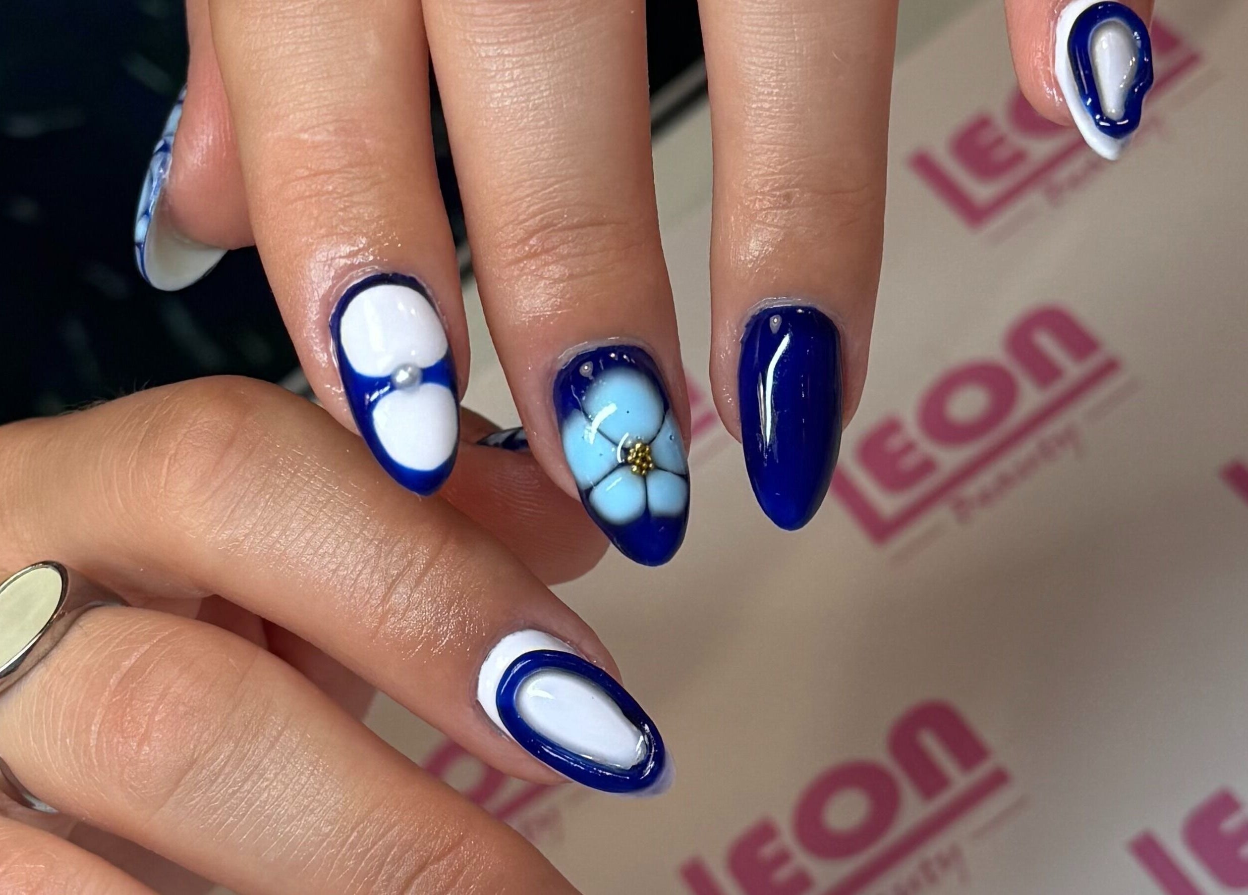Stylish blue and white floral nail art at Glamdolls, Dublin, County Dublin, IE.