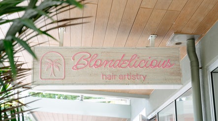 Blondelicious salon sign in Palm Cove, Queensland, AU, showcasing bright, stylish lettering and palm icon.