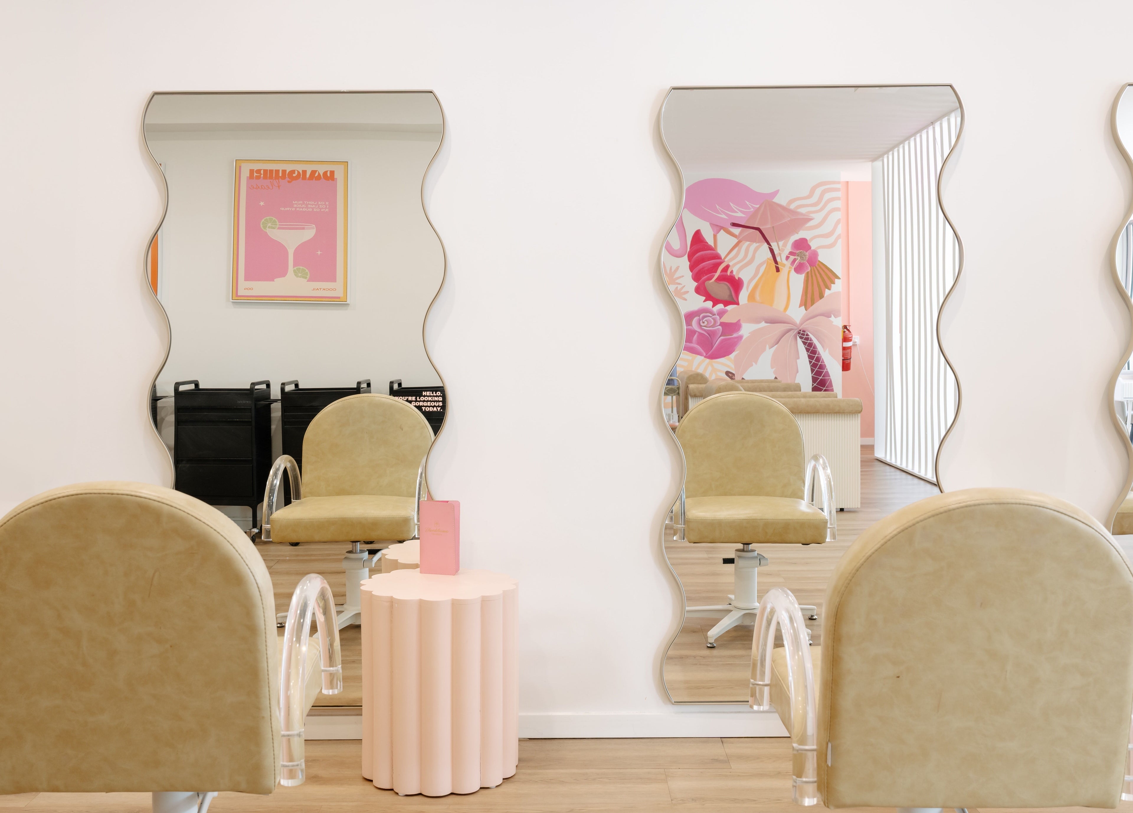 Wave mirrors and chic salon chairs at Blondelicious in Palm Cove, Queensland, AU create a stylish aesthetic.