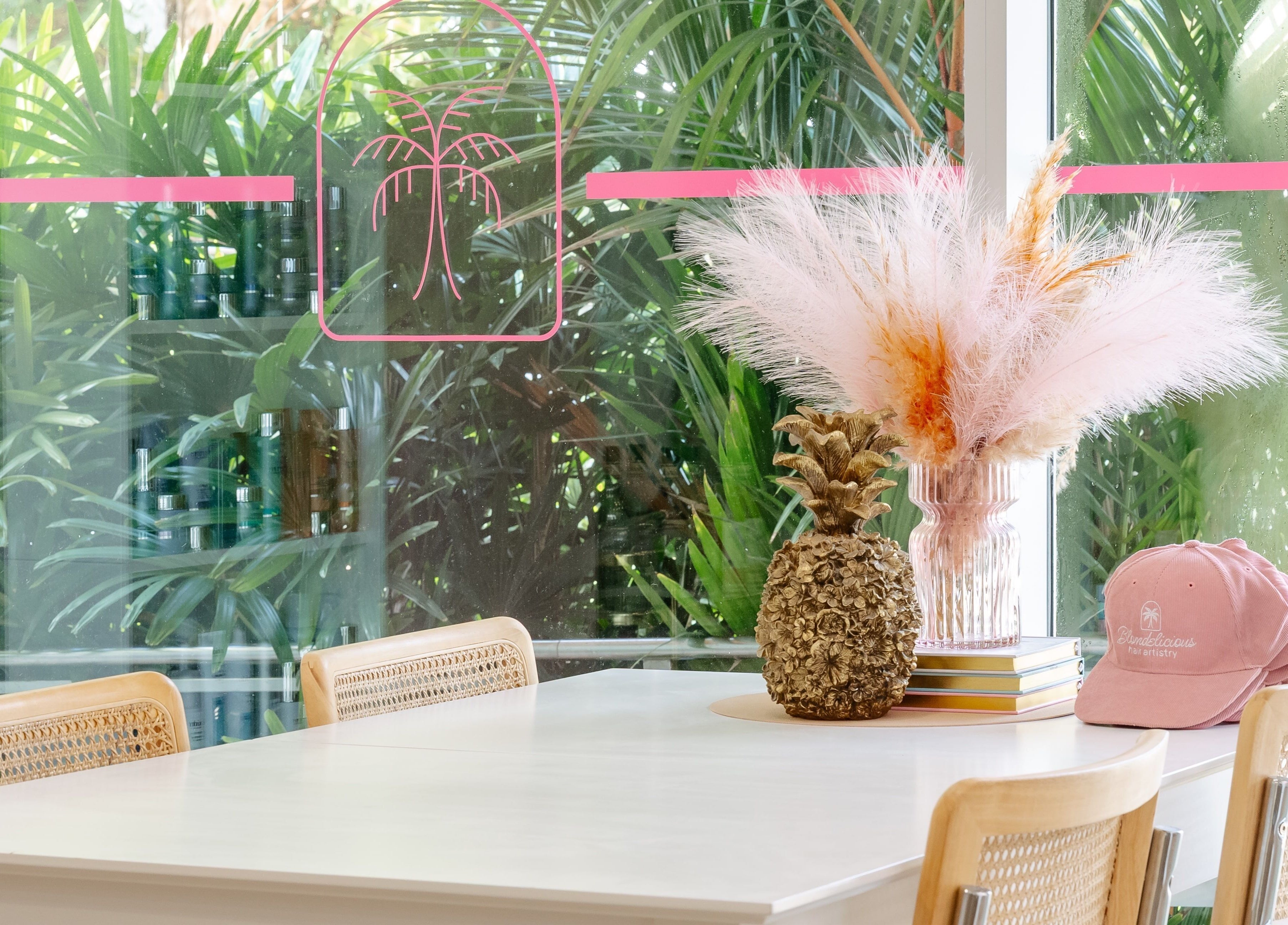 Bright, serene interior of Blondelicious at Palm Cove, Queensland, AU with chic decor and lush greenery.