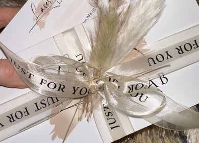 Elegantly wrapped gift card from Laser Lab Yorkshire, Normanton, England, GB, with decorative ribbons.