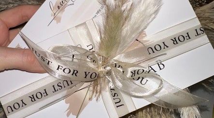 Elegantly wrapped gift card from Laser Lab Yorkshire, Normanton, England, GB, with decorative ribbons.