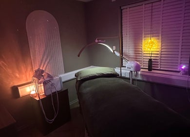 Relaxing treatment room at Laser Lab Yorkshire, Normanton, England, GB, with soft lighting and a massage bed.