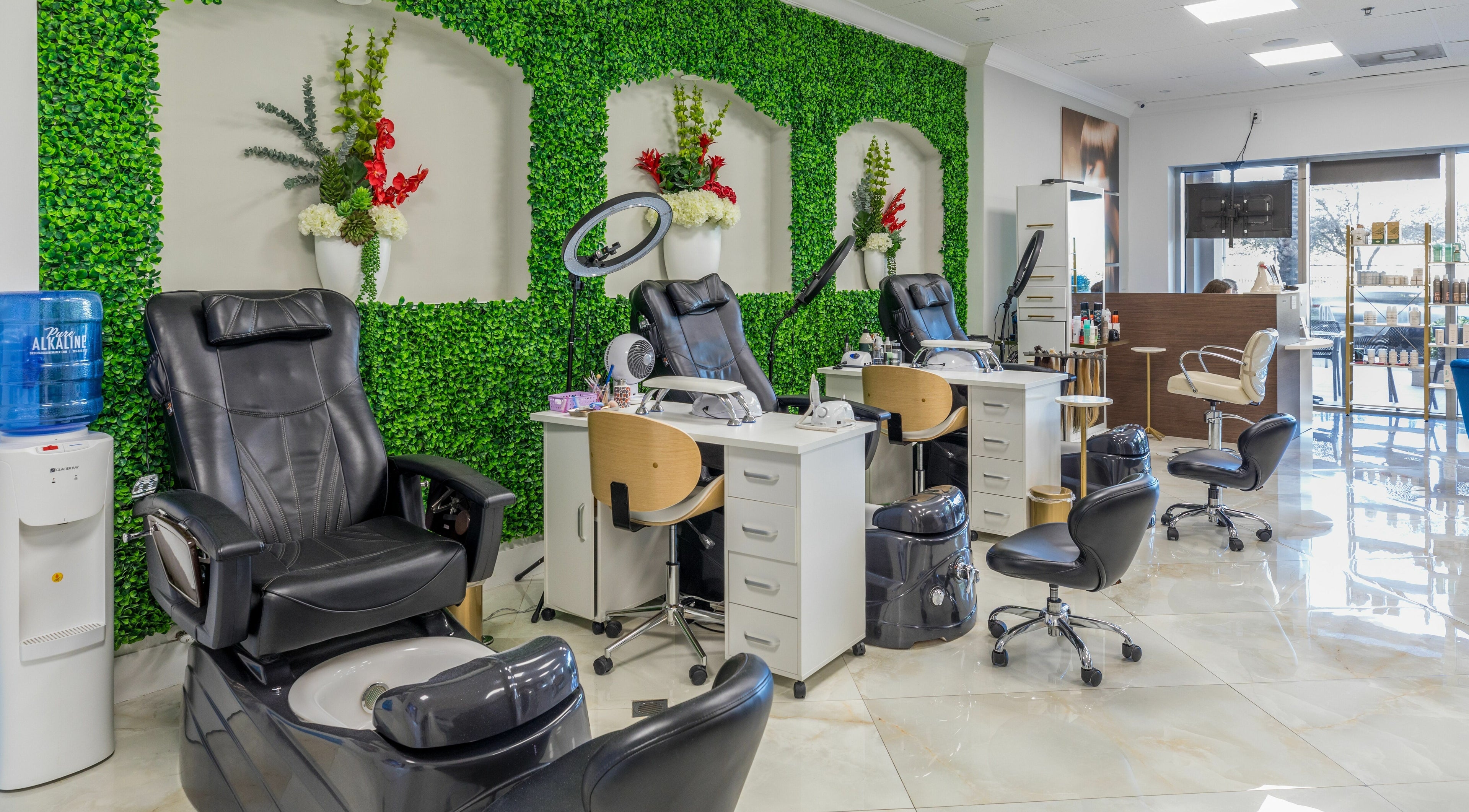 Luxurious salon chairs at Beauty Bar Sunny, Sunny Isles Beach, Florida, US with vibrant greenery.