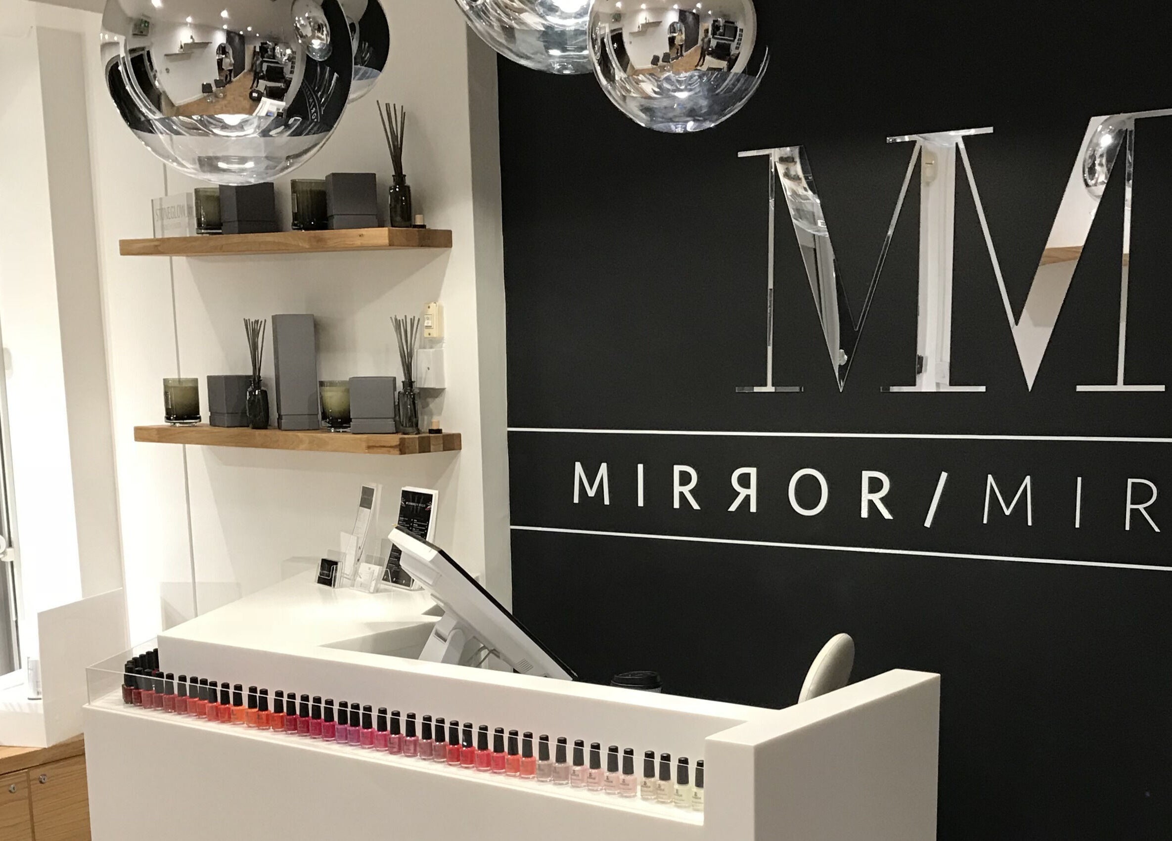 Elegant reception area at Mirror Mirror Shrewsbury, Shrewsbury, GB showcasing modern decor and nail polish display.