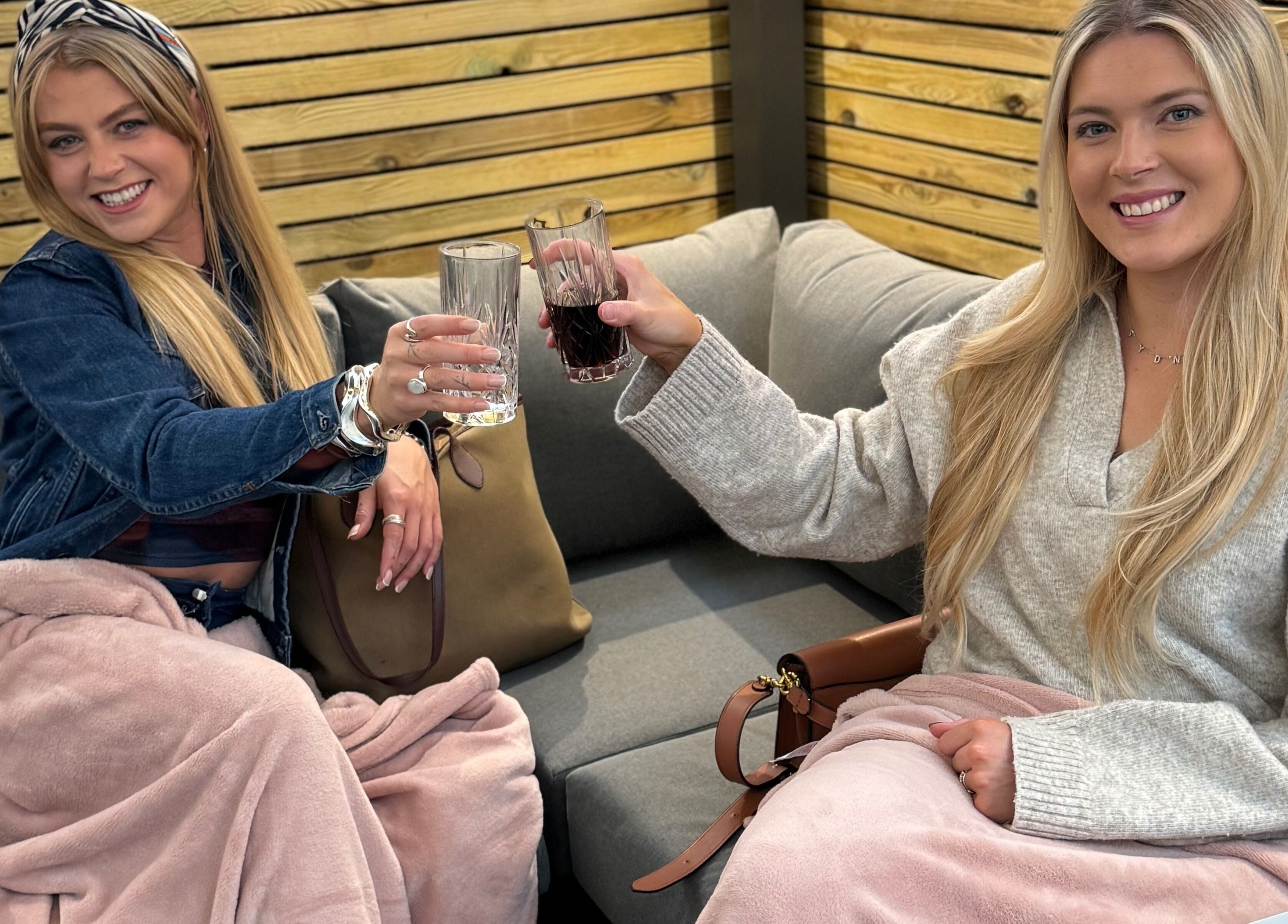 Guests toasting with drinks under blankets at Mirror Mirror Shrewsbury, Shrewsbury, GB.