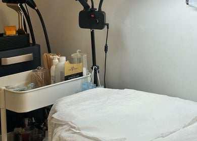 Cozy skincare treatment room at Beautiful You By Lina in Mitcham, England, GB featuring equipment and lotions.