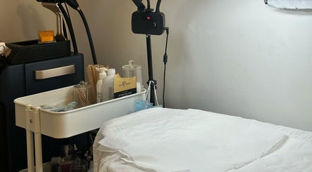 Cozy skincare treatment room at Beautiful You By Lina in Mitcham, England, GB featuring equipment and lotions.
