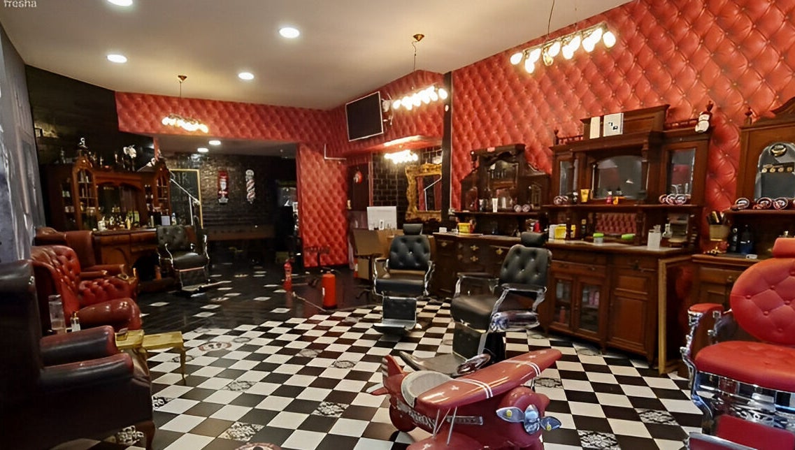 Chic vintage interior of Brazuca B5 Barbers in Carlisle, England, GB, featuring plush chairs and classic decor.
