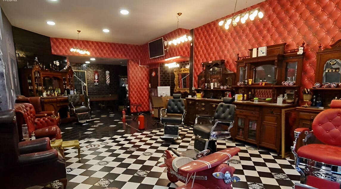 Chic vintage interior of Brazuca B5 Barbers in Carlisle, England, GB, featuring plush chairs and classic decor.