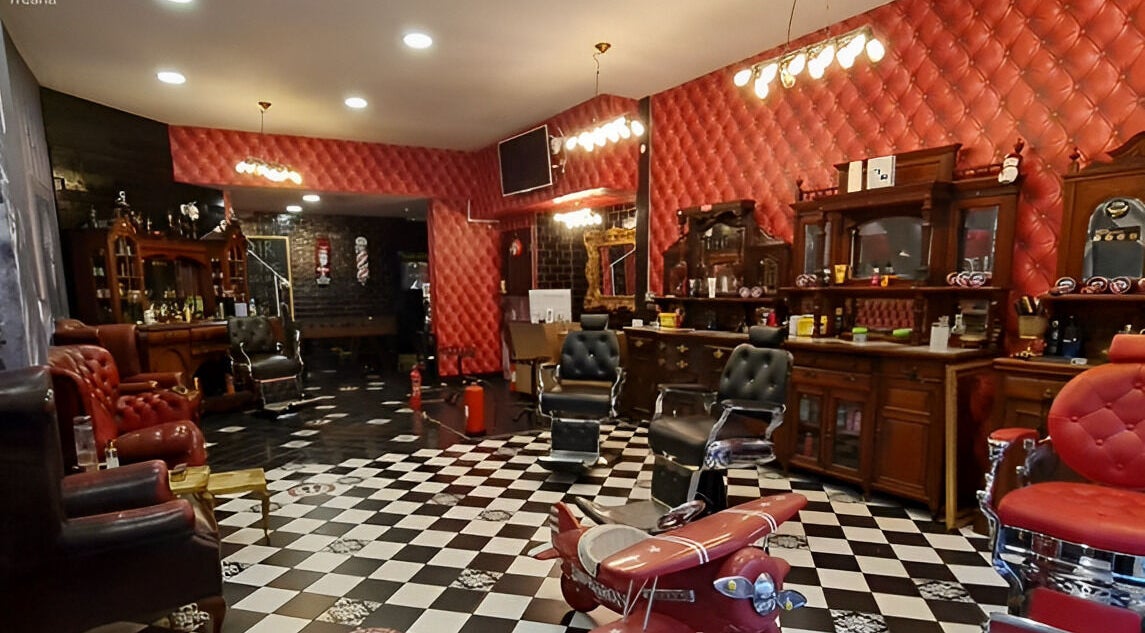 Chic vintage interior of Brazuca B5 Barbers in Carlisle, England, GB, featuring plush chairs and classic decor.