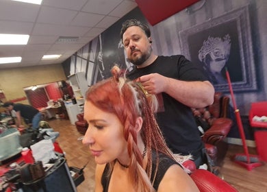 Expert braiding at Brazuca B1 Barbers in Carlisle, England, GB. Stylist meticulously creating intricate braids.