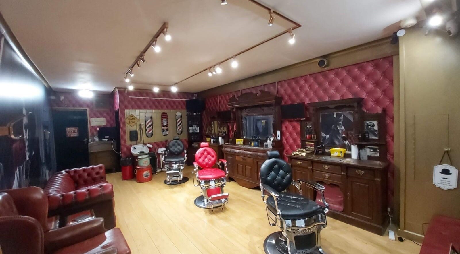 Elegant interior of Brazuca B3 Barbers, Carlisle, England, GB, featuring vintage chairs and classic decor.
