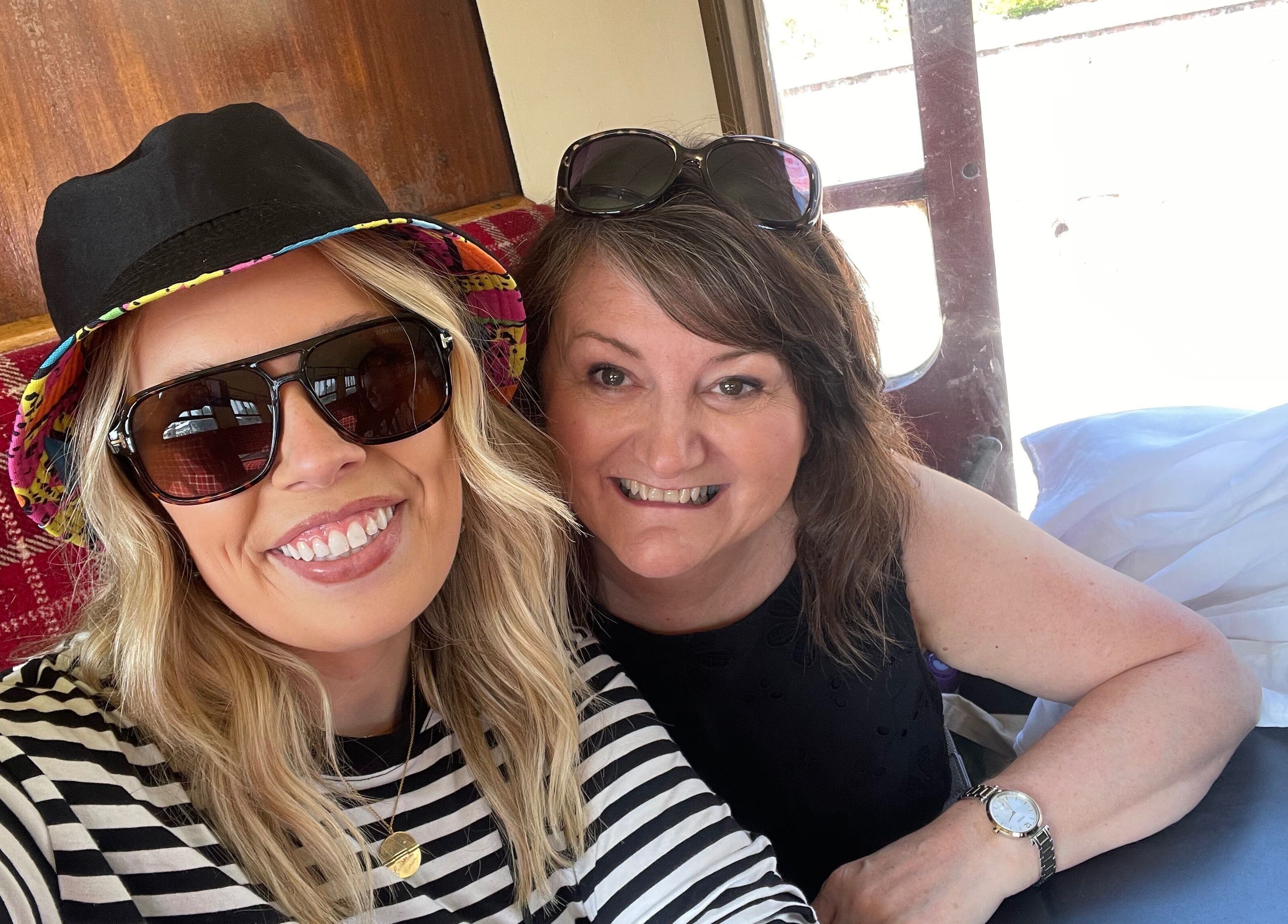 Two smiling women enjoying a comfortable setting at Number 8 Barbers, Brechin, Scotland, GB.