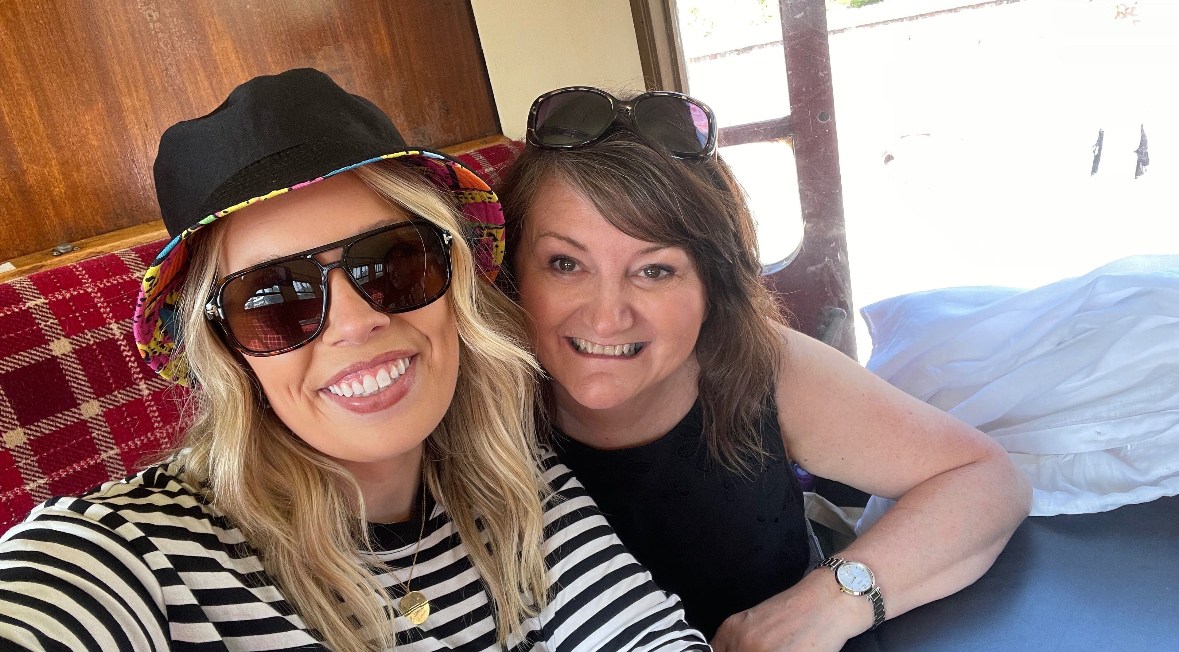 Two smiling women enjoying a comfortable setting at Number 8 Barbers, Brechin, Scotland, GB.