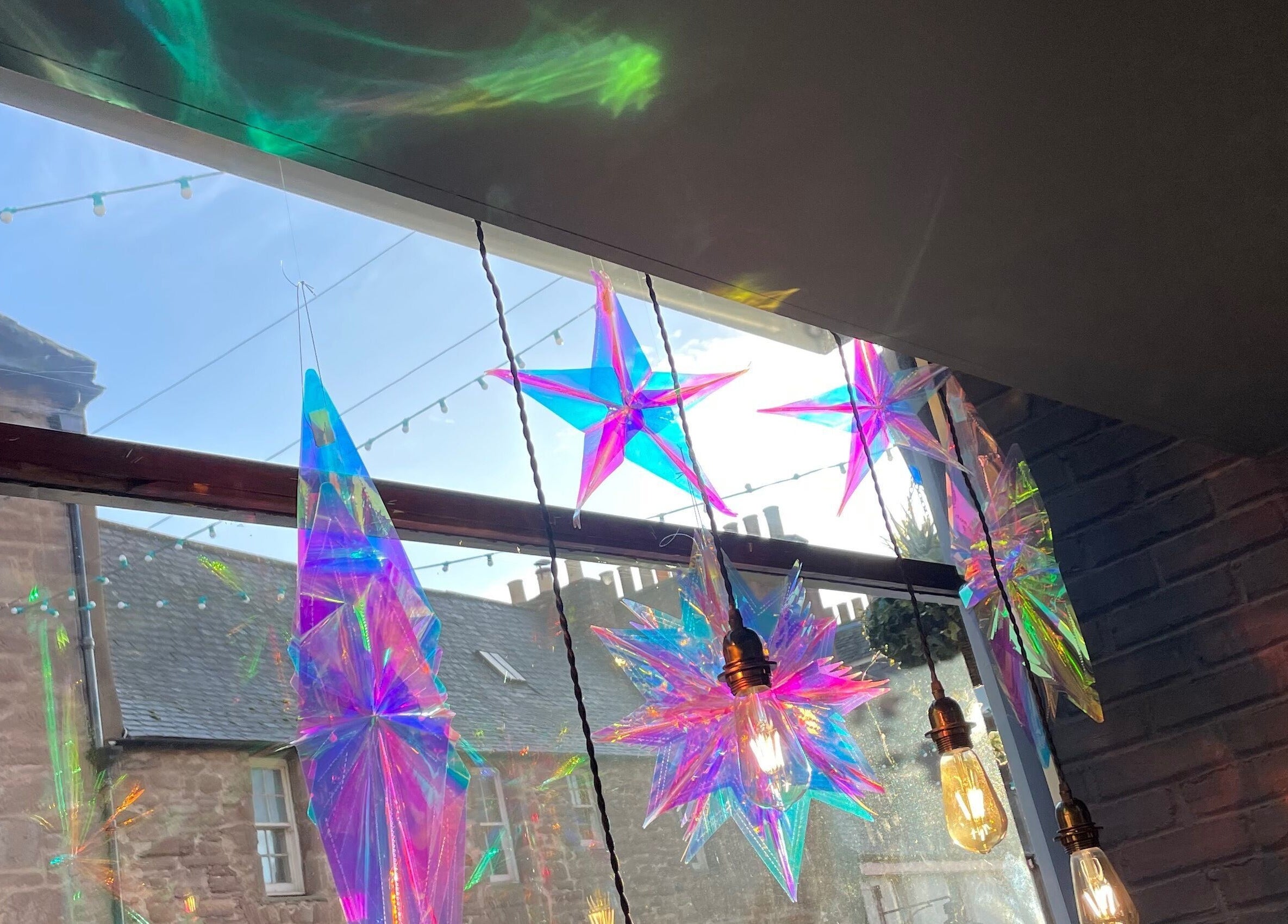 Colorful star decorations and warm lights inside Number 8 Barbers, Brechin, Scotland, GB.