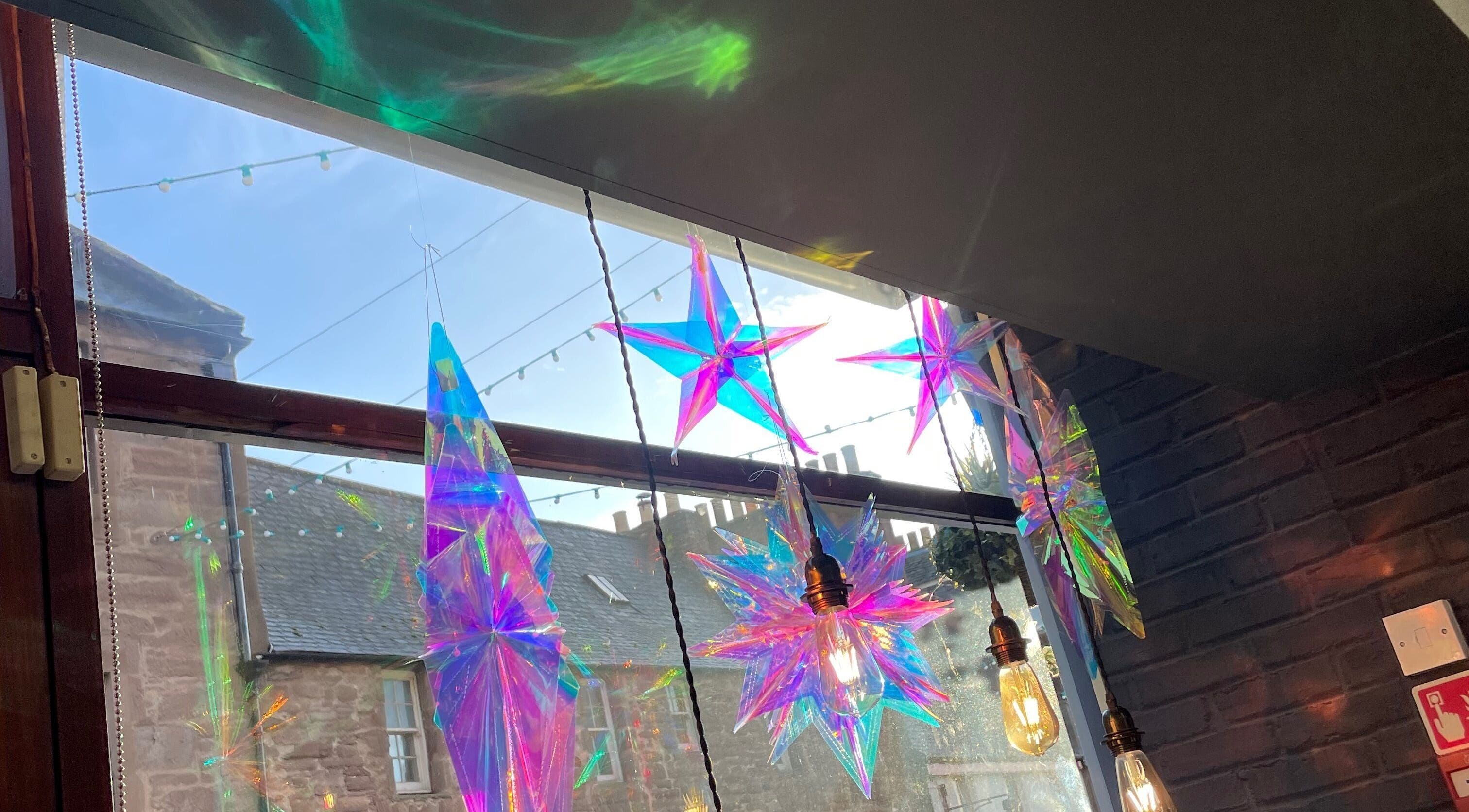 Colorful star decorations and warm lights inside Number 8 Barbers, Brechin, Scotland, GB.
