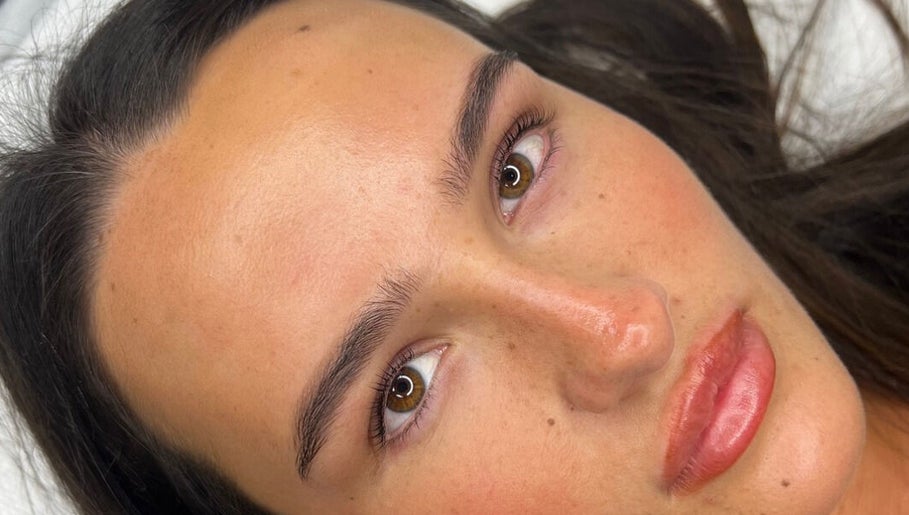 Close-up of a woman's glowing skin at RH Cosmetics, Leeds, England, GB, showcasing natural beauty.