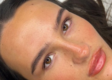 Close-up of a woman's glowing skin at RH Cosmetics, Leeds, England, GB, showcasing natural beauty.