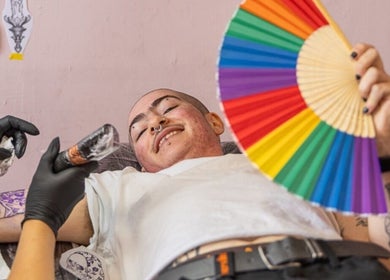 Client smiling during tattoo session at Tattoo Like a Girl Club, Dublin, County Dublin, IE.