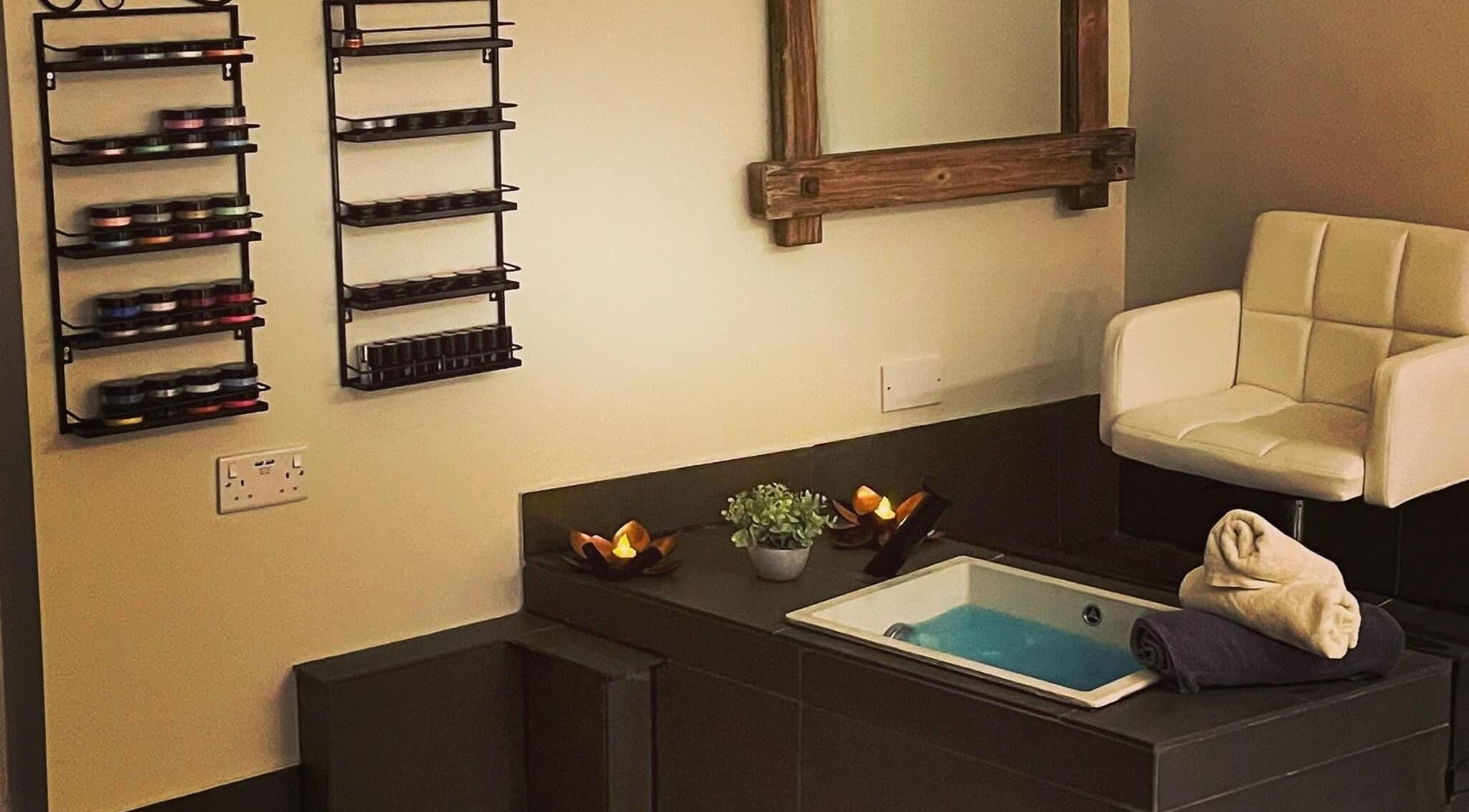 Relaxing spa area at Beau Beauty And Skincare Specialist, Sutterton, England, GB with chair and foot spa.