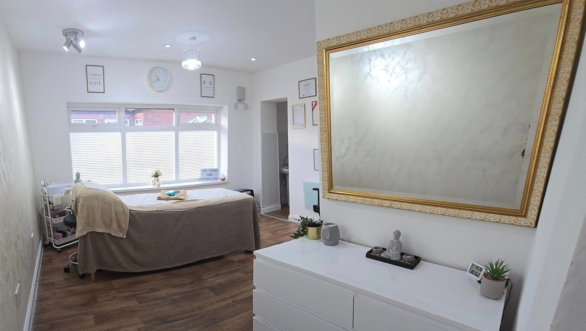 Calming treatment room at KLR Beauty and Brows, Jarrow, England, GB, with mirror, bed, and decor.