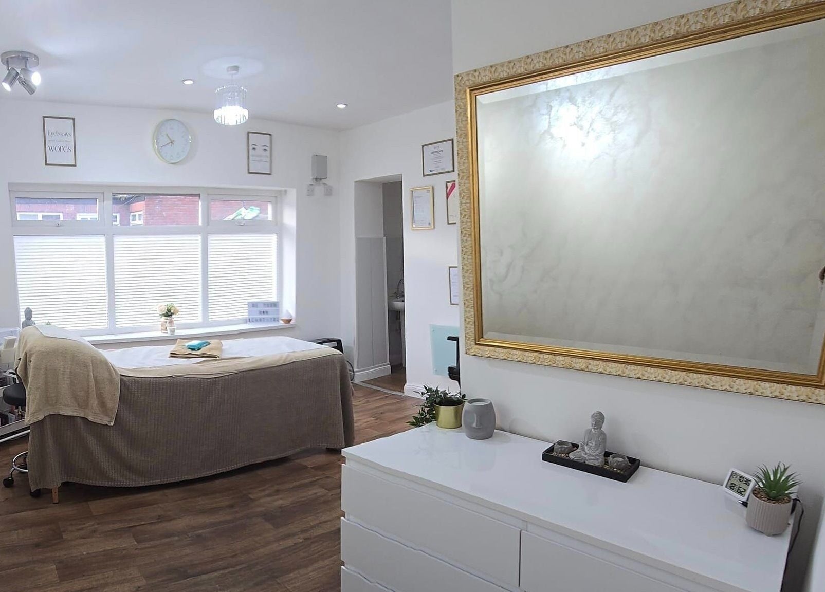 Calming treatment room at KLR Beauty and Brows, Jarrow, England, GB, with mirror, bed, and decor.