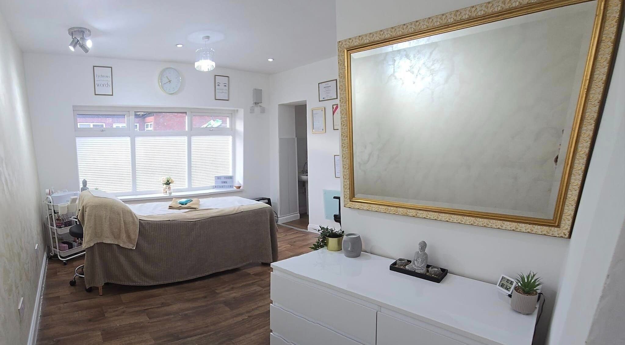 Calming treatment room at KLR Beauty and Brows, Jarrow, England, GB, with mirror, bed, and decor.