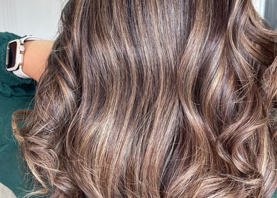 Glossy wavy brown hair styled at Shekinah Studios Ltd in Manukau, Auckland, NZ offers a polished look.