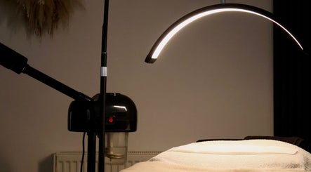 Treatment room setup at Skn By Sonia, Burton Upon Trent, England, GB, featuring ambient lighting.